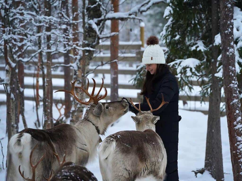 Girl in a snowy landscape outside Rovaniemi, Finland on a reindeer farm